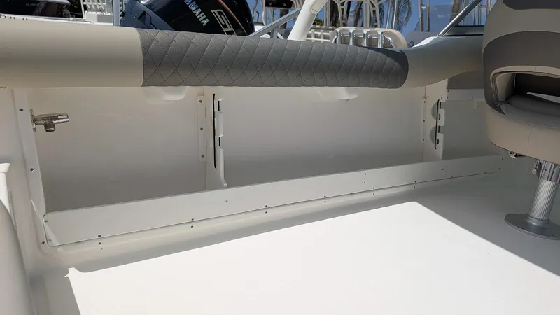 Slide: The Image of 2025 Key West 239 DFS boat interior with cushioned seating and storage compartment. - 8