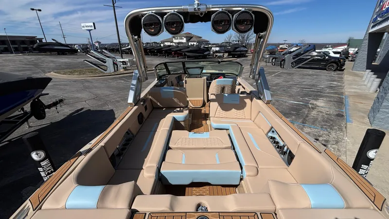 Slide: The Image of 2025 MasterCraft X26 boat interior with beige and blue seating, showcasing luxury and spacious design. - 14
