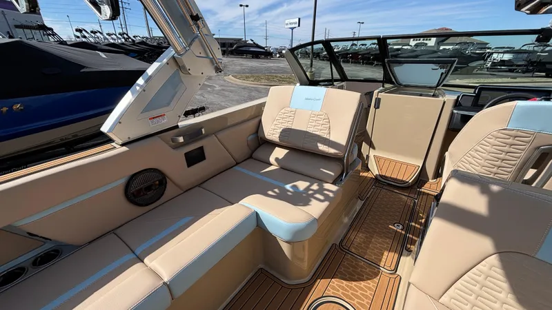 Slide: The Image of 2025 MasterCraft X26 boat interior with beige and blue seating, showcasing luxury and comfort. - 22