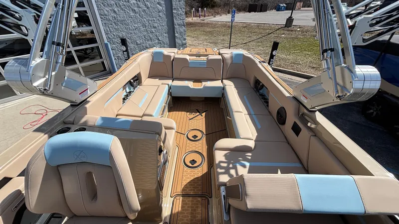 Slide: The Image of 2025 MasterCraft X26 boat interior with beige and blue seating, showcasing luxury and spacious design. - 23
