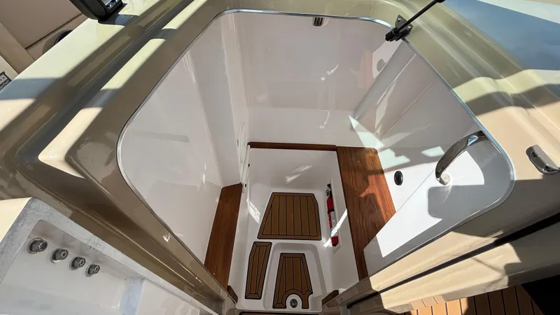 Slide: The Image of 2025 MasterCraft X26 boat interior with sleek design and wood accents. - 30