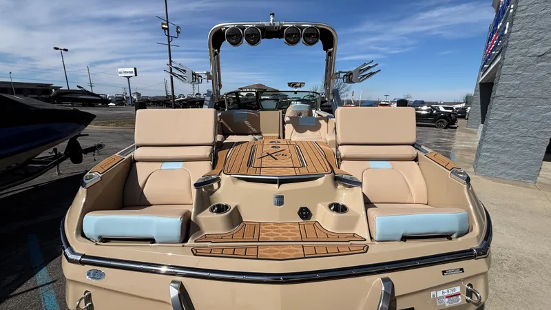 Slide: The Image of 2025 MasterCraft X26 boat with luxurious seating and sleek design, displayed outdoors. - 5