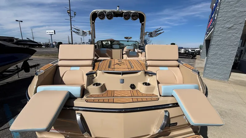 Slide: The Image of 2025 MasterCraft X26 boat with luxurious seating and sleek design, showcased outdoors. - 6
