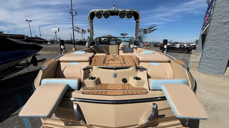 Slide: The Image of 2025 MasterCraft X26 boat with luxurious seating and sleek design, displayed outdoors. - 7