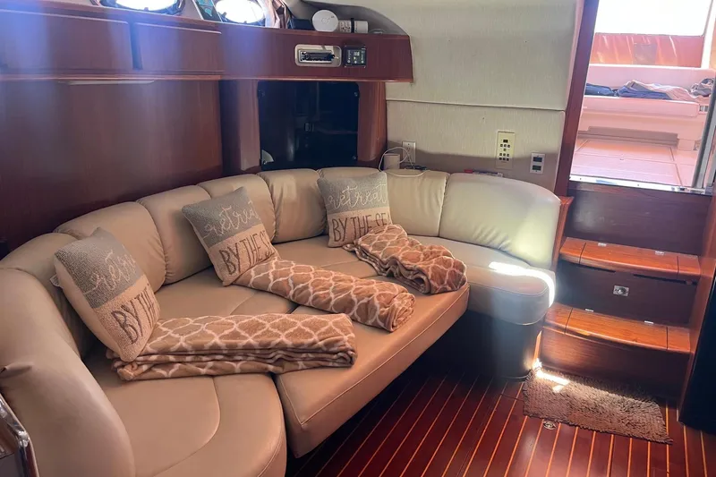 Slide: The Image of Luxurious interior of 1994 Sea Ray 400 Express Cruiser with cozy seating and nautical decor. - 13