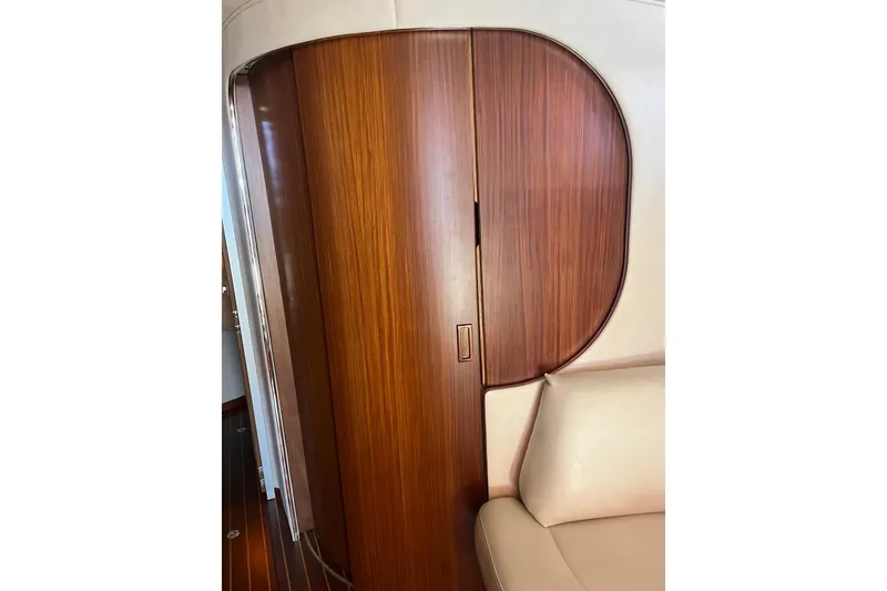Slide: The Image of Interior of 1994 Sea Ray 400 Express Cruiser with wooden cabinetry and beige seating. - 16