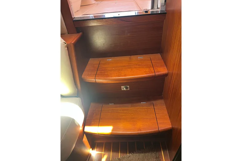 Slide: The Image of Wooden steps inside a 1994 Sea Ray 400 Express Cruiser, showcasing elegant craftsmanship. - 17
