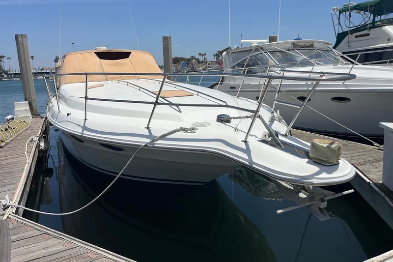 Slide: The Image of 1994 Sea Ray 400 Express Cruiser docked at marina under clear blue sky. - 18