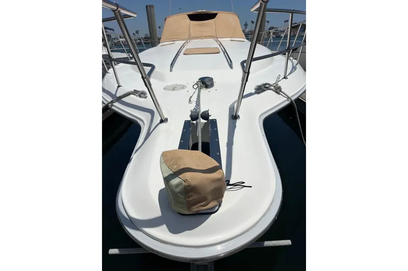 Slide: The Image of 1994 Sea Ray 400 Express Cruiser bow with anchor and beige cover. - 19