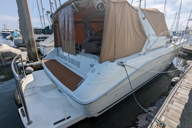 Slide: The Image of 1994 Sea Ray 400 Express Cruiser docked at marina with tan canopy. - 20