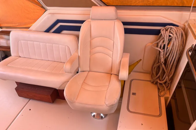 Slide: The Image of 1994 Sea Ray 400 Express Cruiser interior with beige seating and coiled rope. - 6