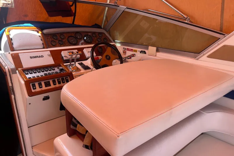Slide: The Image of 1994 Sea Ray 400 Express Cruiser helm with Simrad electronics and leather seating. - 7