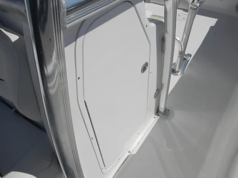 Slide: The Image of 2016 Sea Hunt Ultra 234 boat interior, featuring a sleek white compartment door. - 10