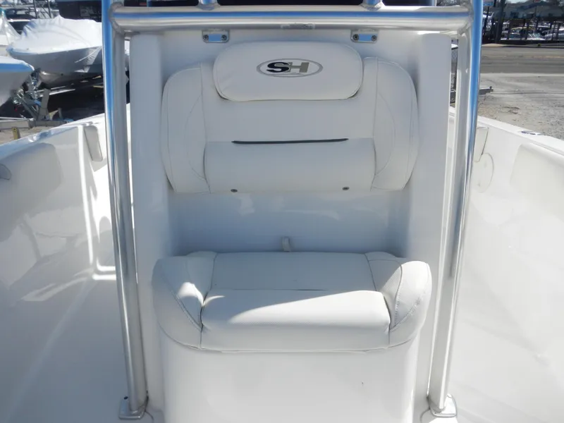 Slide: The Image of 2016 Sea Hunt Ultra 234 boat seat with white cushioned backrest and logo. - 12