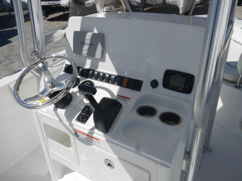 Slide: The Image of 2016 Sea Hunt Ultra 234 boat console with steering wheel and controls. - 14