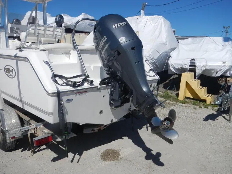 Slide: The Image of 2016 Sea Hunt Ultra 234 boat with Yamaha 200 outboard motor, parked on a trailer. - 4