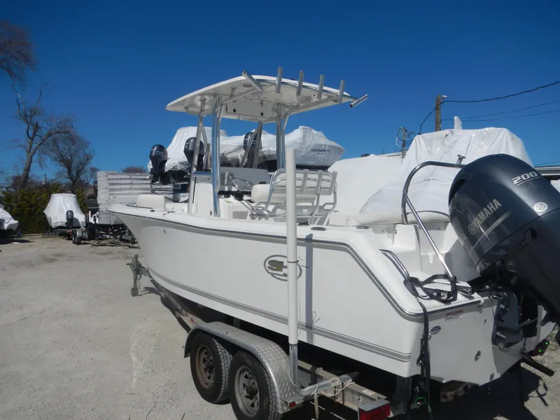Slide: The Image of 2016 Sea Hunt Ultra 234 boat on trailer with Yamaha 200 engine, parked outdoors. - 5