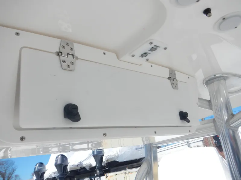 Slide: The Image of 2016 Sea Hunt Ultra 234 boat storage compartment with secure latches and visible hardware. - 7