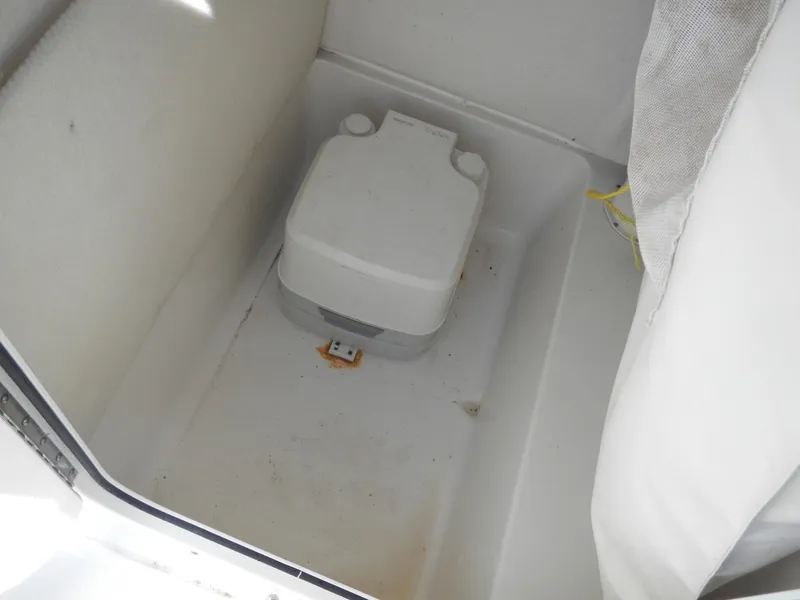 Slide: The Image of 2016 Sea Hunt Ultra 234 boat interior with portable toilet. - 9