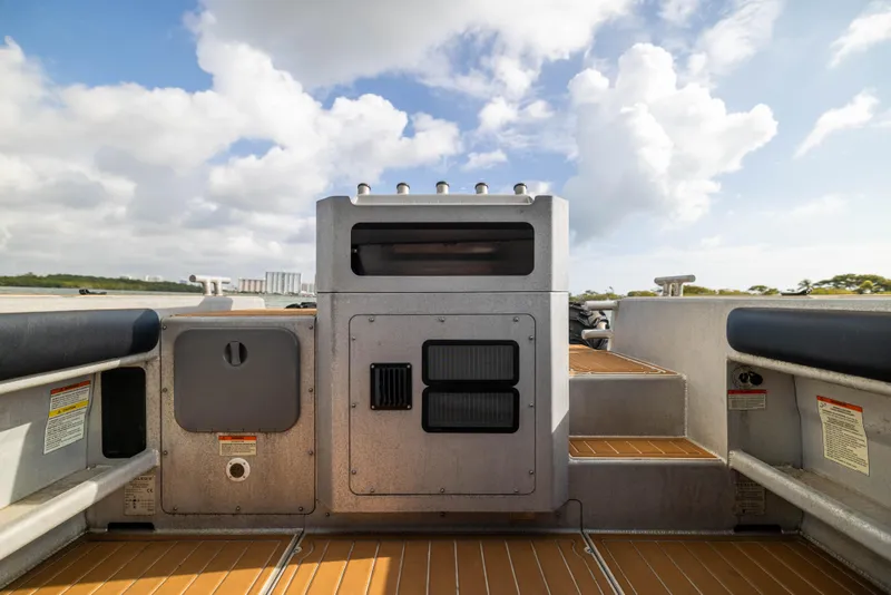 Slide: The Image of 2022 Sealegs 8.5M boat interior with control panel, wooden flooring, and clear sky. - 10