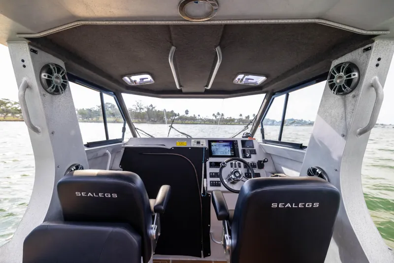 Slide: The Image of Interior of 2022 Sealegs 8.5M boat with modern dashboard and dual seating. - 13