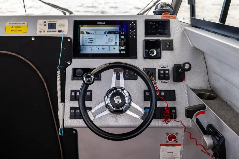 Slide: The Image of Control panel of a 2022 Sealegs 8.5M boat with steering wheel and navigation display. - 16