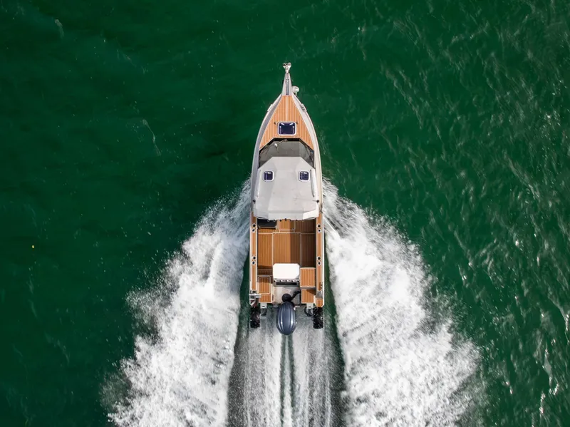 Slide: The Image of Overhead view of 2022 Sealegs 8.5M boat cruising on green water. - 2