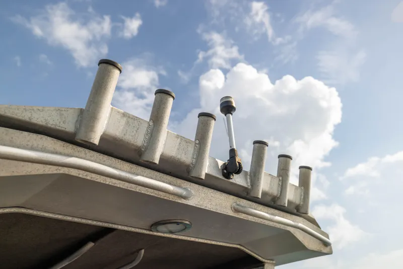 Slide: The Image of Sealegs 8.5M 2022 boat roof with rod holders against a cloudy sky. - 20