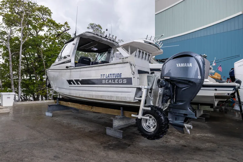 Slide: The Image of 2022 Sealegs 8.5M boat with Yamaha engine on display in a marina setting. - 27