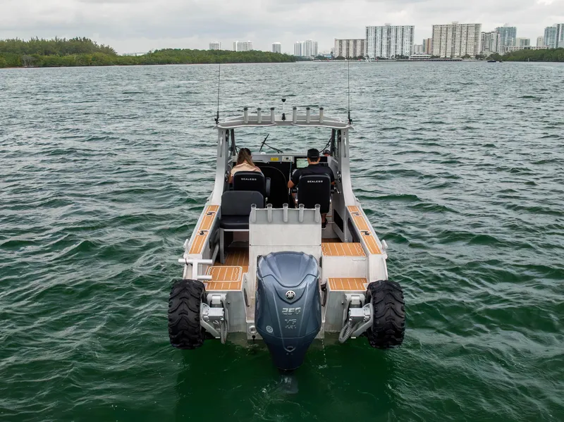 Slide: The Image of Sealegs 8.5M 2022 amphibious boat on water, rear view with city skyline. - 30