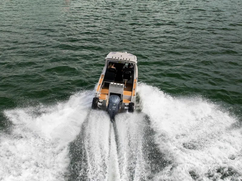 Slide: The Image of Sealegs 8.5M 2022 boat cruising on water, rear view, creating waves. - 33
