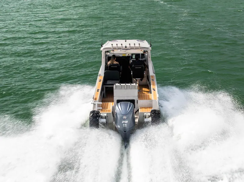 Slide: The Image of Sealegs 8.5M 2022 boat cruising on water, rear view with powerful engine. - 35