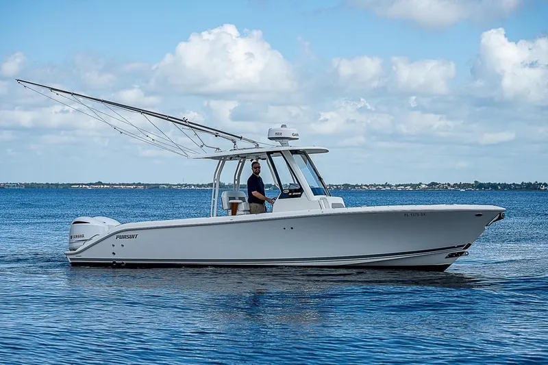 Slide: The Image of 2021 Pursuit S 288 Sport boat cruising on calm blue waters under a cloudy sky. - 2