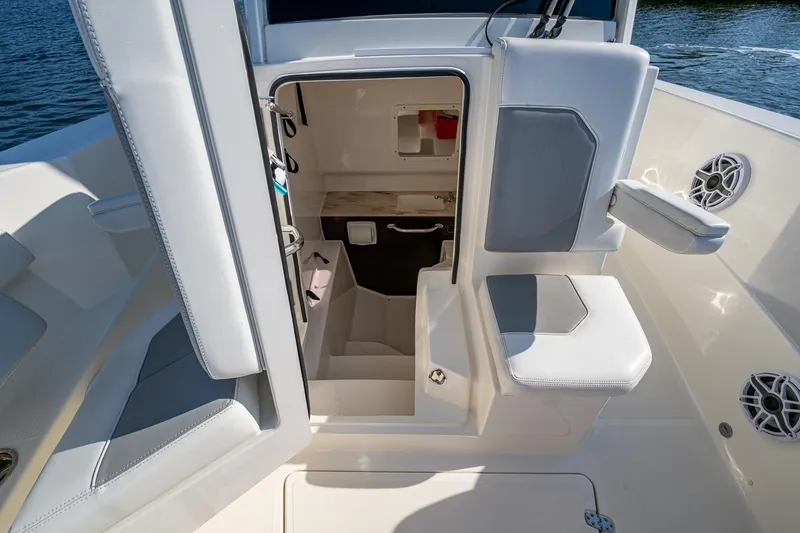 Slide: The Image of 2021 Pursuit S 288 Sport boat interior with seating and cabin entrance. - 26