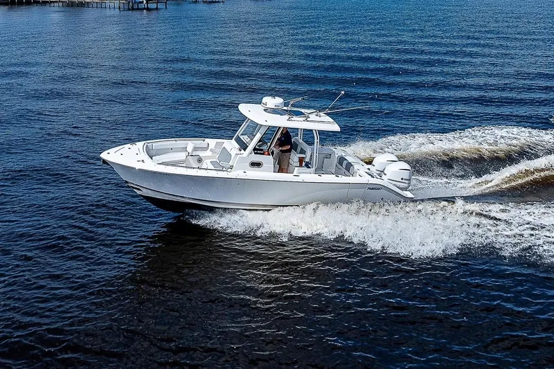 Slide: The Image of 2021 Pursuit S 288 Sport boat cruising on open water, creating a dynamic wake. - 3