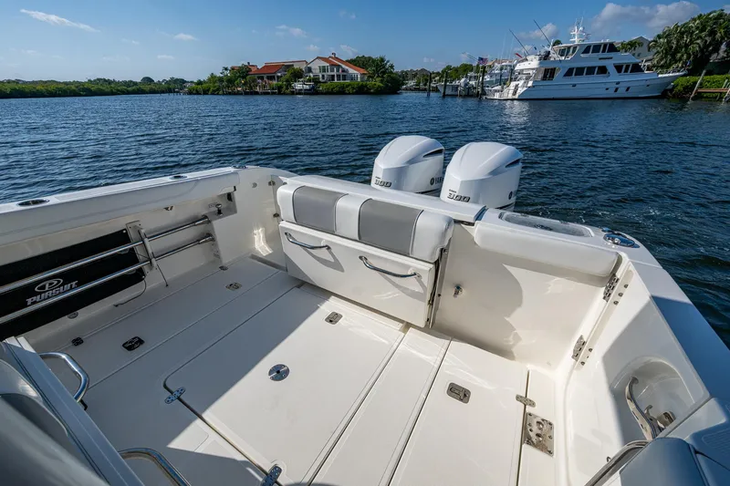 Slide: The Image of 2021 Pursuit S 288 Sport boat with dual engines on a sunny waterfront. - 35