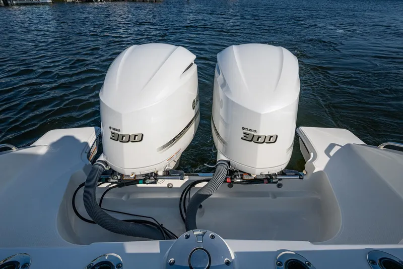 Slide: The Image of Twin Yamaha 300 engines on a 2021 Pursuit S 288 Sport boat, docked on water. - 39