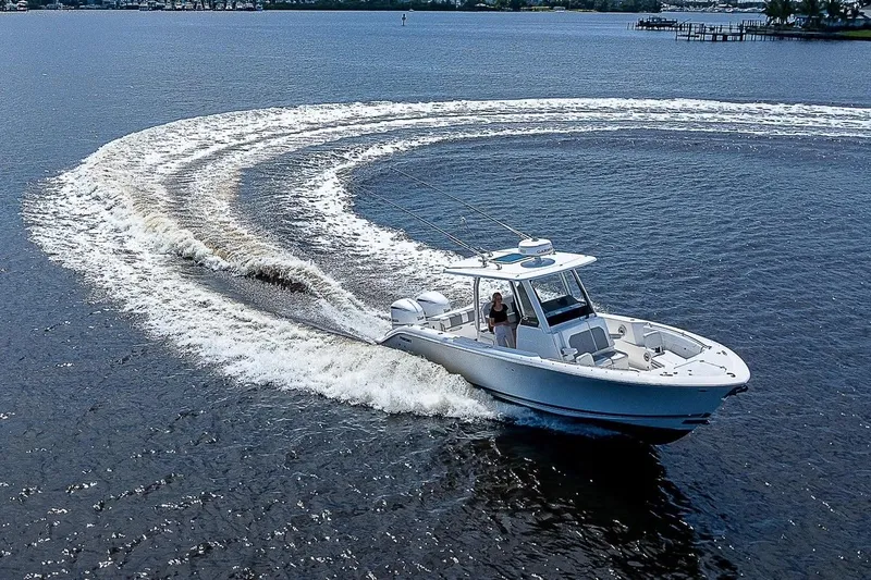 Slide: The Image of 2021 Pursuit S 288 Sport boat making a sharp turn on open water. - 4