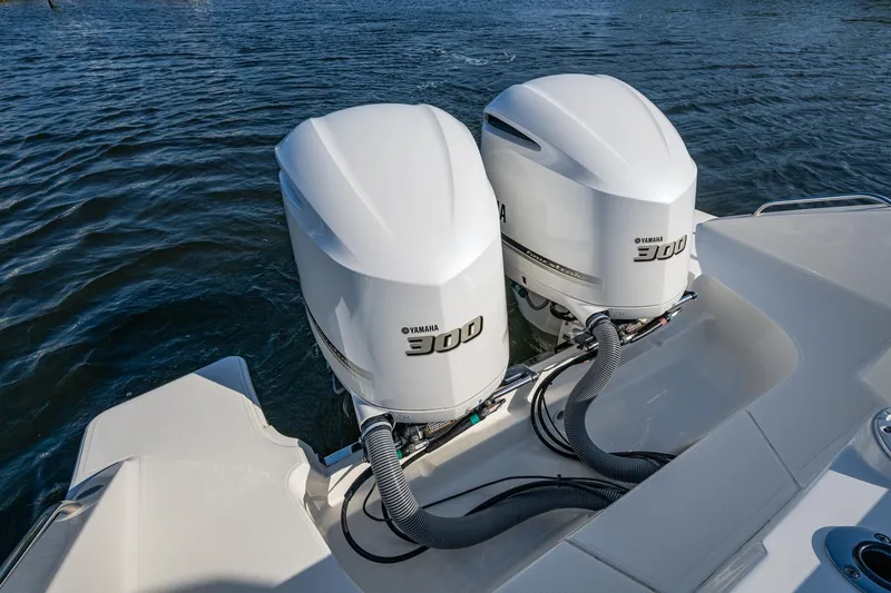 Slide: The Image of Twin Yamaha 300 engines on a 2021 Pursuit S 288 Sport boat, docked on water. - 40