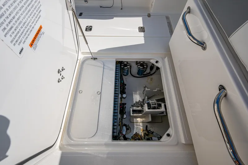 Slide: The Image of 2021 Pursuit S 288 Sport boat showing open hatch with internal components visible. - 43