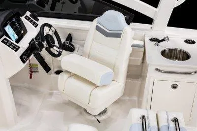 Slide: The Image of 2025 Robalo R257 DC boat interior with helm, luxurious seating, and sink. - 14
