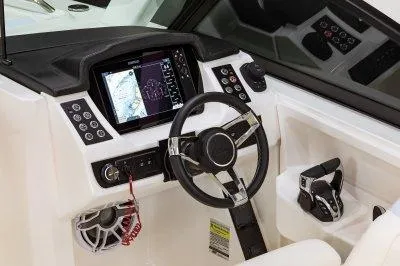 Slide: The Image of 2025 Robalo R257 DC boat dashboard with steering wheel and navigation system. - 15