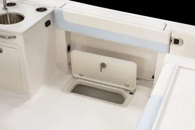 Slide: The Image of 2025 Robalo R257 DC boat interior with storage compartment and sink. - 24
