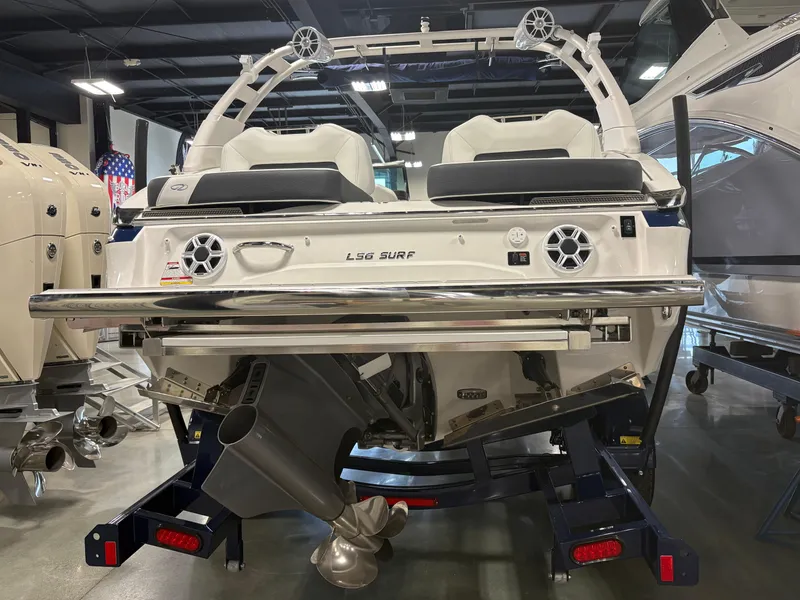 Slide: The Image of 2026 Regal LS6 Surf boat rear view in showroom, showcasing sleek design and powerful engine. - 3