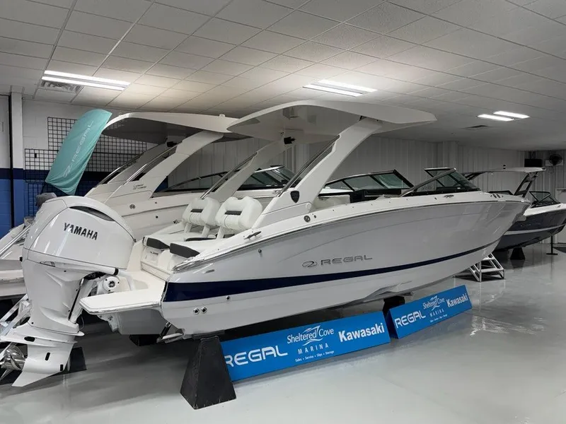 Slide: The Image of 2026 Regal LX6 boat with Yamaha engine displayed indoors at a showroom. - 10