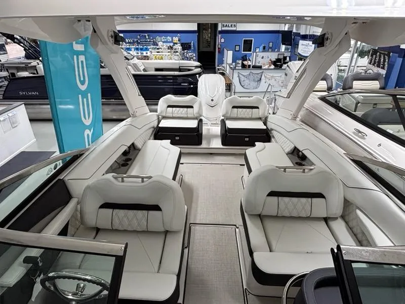 Slide: The Image of 2026 Regal LX6 boat interior with luxurious seating and modern design in showroom. - 19