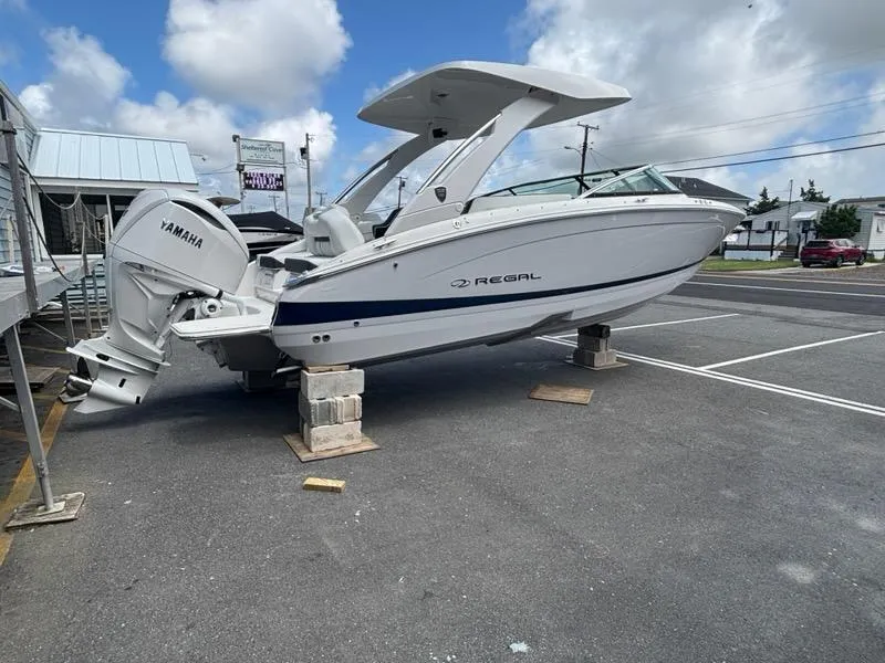 Slide: The Image of 2026 Regal LX6 boat with Yamaha engine on display in a parking lot. - 3