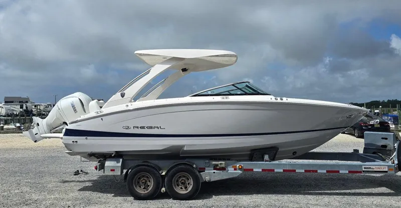 Slide: The Image of 2026 Regal LX6 boat on trailer, side view, cloudy sky background. - 5