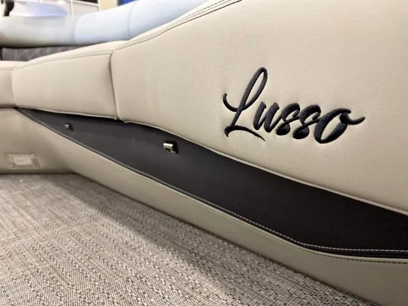Slide: The Image of 2024 Lusso Ultra-Lounge 25UC interior with elegant embroidered logo on beige upholstery. - 18