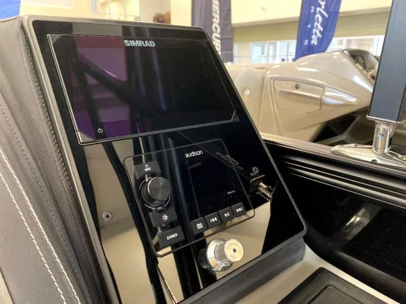 Slide: The Image of 2024 Lusso Ultra-Lounge 25UC dashboard with Simrad and Audison controls. - 22